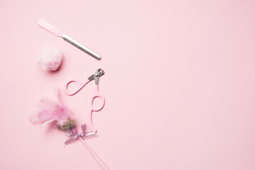 A set for trimming pet claws: a file and a nail cutter, feathers toy, fur pom-poms. Pink cat nail clipper.