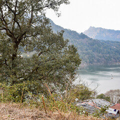 Full view of Naini Lake during evening time near Mall Road in Nainital, Uttarakhand, India, Beautiful view of Nainital Lake with mountains and blue sky