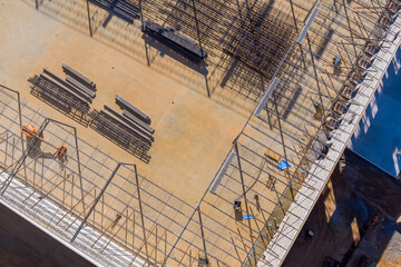 Fototapeta premium Installation of the roof truss metal frame on the steel warehouse roof of the industrial building