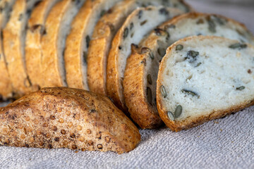 Sliced fresh whole wheat bread with pumpkin seeds close-up