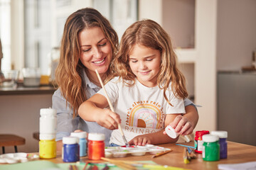Mother, girl and painting art in house studio, home or creative space with brush, oil paint or...