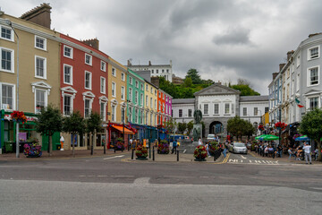town square in Cobh with colorful houses and the Lusitania Memorial statue