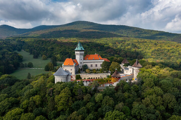 Fototapeta na wymiar view of Smolenice Castle in the Little Carpathians in green late summer forest