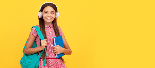 happy school teen girl in headphones carry backpack and workbook, elearning. Banner of school girl student. Schoolgirl pupil portrait with copy space.