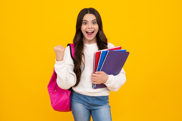 School teenager child girl 12, 13, 14 years old with book and copybook. Teenager schoolgirl on isolated background. Learning and knowledge education concept. Excited teenager girl.