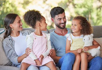 Happy family, parents and girl children on sofa bonding, love affection and care together at family...