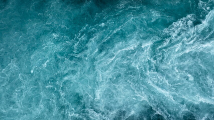 Aerial view of the waves and rapids of the wild river, close-up, top shot