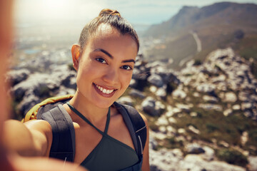 Portrait, happy and woman hiking with a selfie in nature on a mountain during summer. Face, fitness...