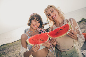 Photo of youngster sisters people 60s style picnic hold slice watermelon wear boho outfit nature seaside beach outside