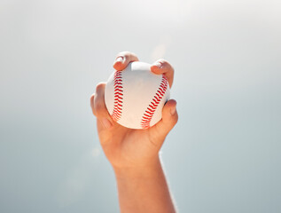 Baseball, athlete hands and ball sports while showing grip of pitcher against a clear blue sky. Exercise, game and softball with a professional player ready to throw or pitch during a match outside - obrazy, fototapety, plakaty