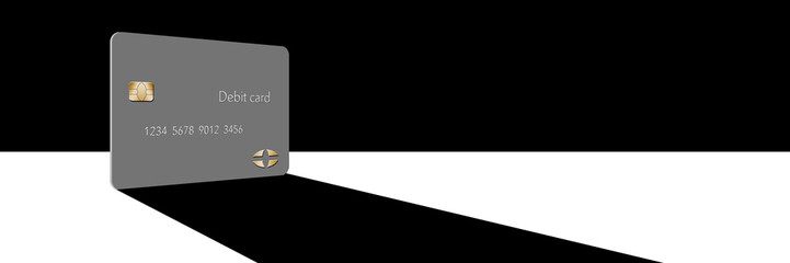 A debit card casts a shadow in this minimalist image with limited color mixed with grey, blacks and whites.