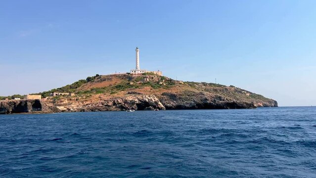 Low angle seawater pov of famous Santa Maria di Leuca lighthouse in Southern Italy seen from sailing tour boat