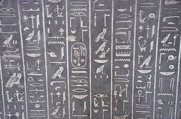 Egyptian hieroglyphs engraved in stone
