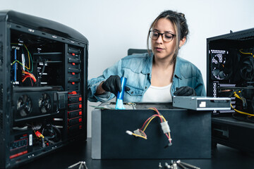 Woman repairing pc and using small brush for cleaning inside of desktop cabinet