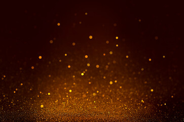 Fototapeta na wymiar particles on a dark brown background. glitter background