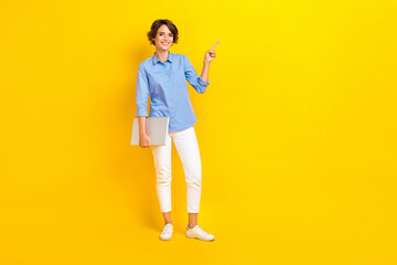 Full size photo of cheerful woman bob hairdo dressed blue blouse indicating empty space hold laptop...