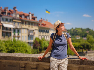 Obraz premium having great vacation in Switzerland, BErn. Lady visiting tourist attractions and landmarks. Woman tourist on top of cityscape view to old town of Bern