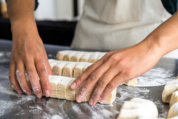Close-up shot of female baker's hands making pastry