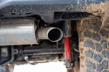 SUV car exhaust muffler or resonator and tip. Low angle view, no people