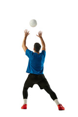 Muscular athlete, male volleyball player training with ball isolated on white studio background....