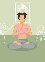 Young woman doing yoga in faceless style on the green background