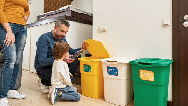 Mom near father teach son throw bottle in dustbin