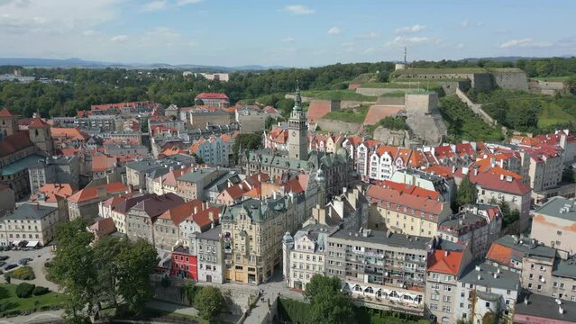 Kłodzko - a city situated in the mountains. Sunny day and clouds in the blue sky in the mountains.