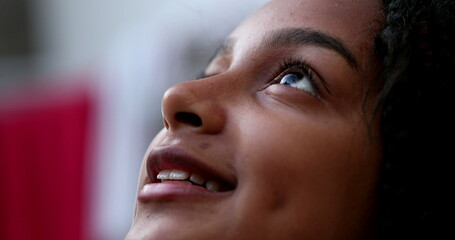 Hispanic black girl child opening eyes to sky smiling face close-up
