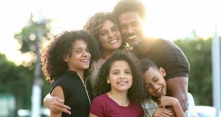 Happy beautiful African Brazilian family outside smiling