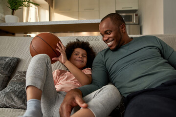 Dad look at son during watch basketball broadcast