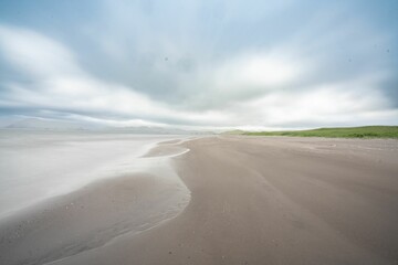 Scenic view of the sandy shore of the Kuluk bay beach on Adak Island