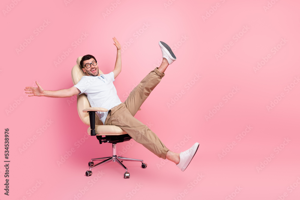 Wall mural full length photo of playful manager guy relax after work ride fast chair isolated on pastel color b - Wall murals