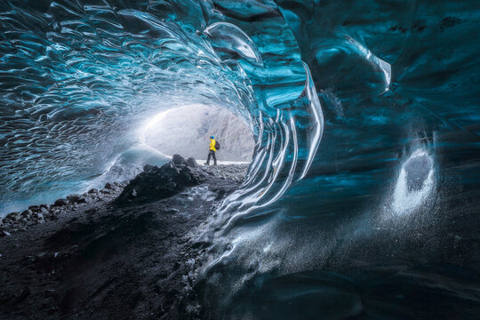 Traveler inside ice cave in daytime