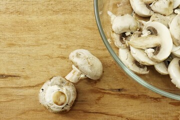 Champignon mushrooms on wood background