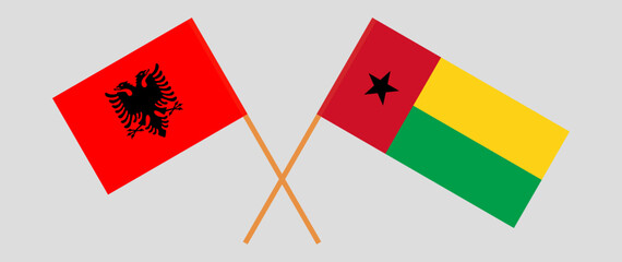 Crossed flags of Albania and Guinea-Bissau. Official colors. Correct proportion