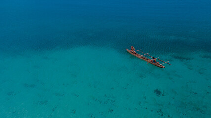 Boat in the middle of the blue sea, location in Pasir Putih Manokwari, West Papua Province
