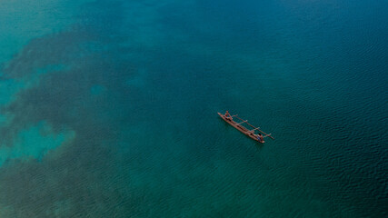 Boat in the middle of the blue sea, location in Pasir Putih Manokwari, West Papua Province