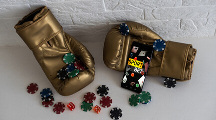 boxing gloves and smartphone with bets.
