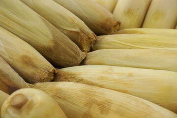 piles of raw corn being peddled in the market  
