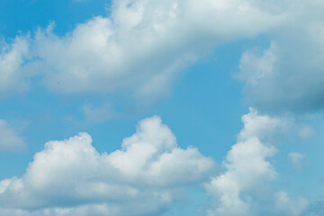 many beautiful white clouds in the sky.