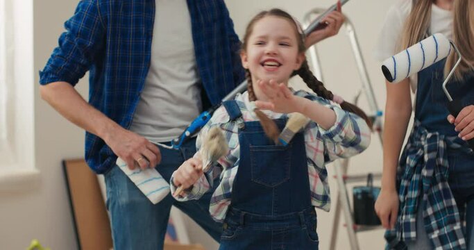 Family that recently bought their dream home has started welcome renovation. Everyone is delighted with process and sings and dances with joy. Instead of real microphones paint mops and brushes.