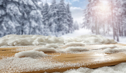 Wooden table with snow at sunset on a frosty winter's day and a free seat