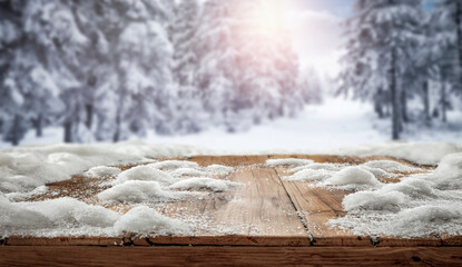Fototapeta na wymiar Wooden table with snow at sunset on a frosty winter's day and a free seat