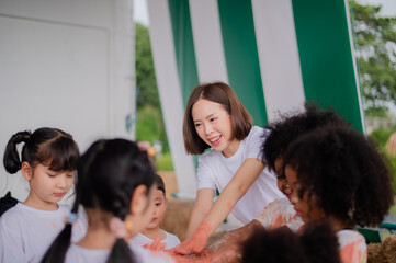 Obraz premium teacher and children playing color in Art join hand in hand fun together