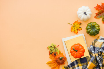 Fall office workspace. Autumn flat lay background. Autumn cloth and fall decorations - pumpkin, leaves and other.