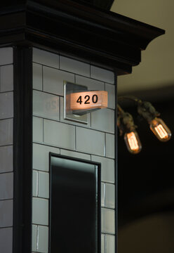 A number above the door, 420, in a city at night.