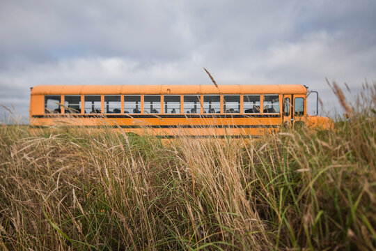 Empty school bus in grassland.
