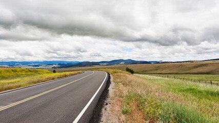Road running through grassland.