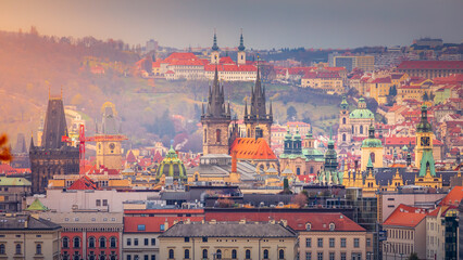 Obraz premium Above medieval Prague old town towers and domes at evening, Czech