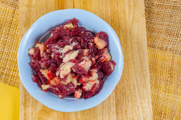 Heap of raw chopped beef, Fresh beef slice in a bowl on a wooden chopping bord.